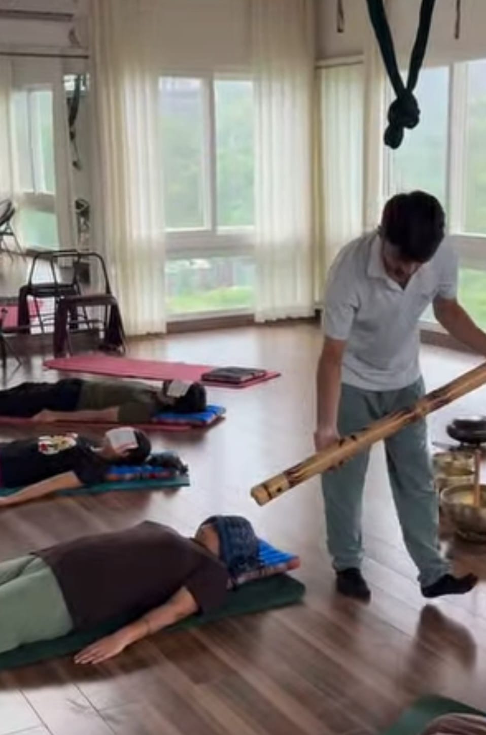 Aditya Panwar facilitating a corporate wellbeing class with a bamboo sound instrument
